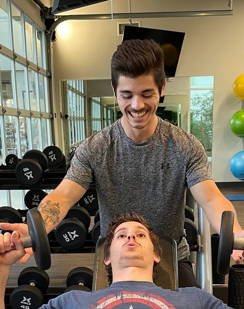 Coach Eric training client with weights in Phoenix