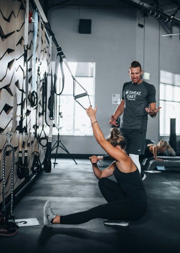 Fitness coaching clients training together in Phoenix gym