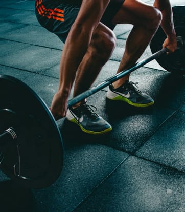 Client performing barbell squat with proper form